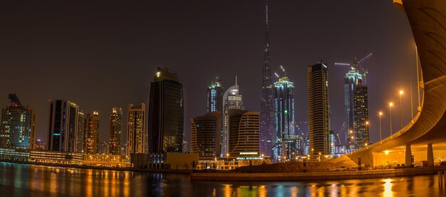 Illuminated cityscape against sky at night