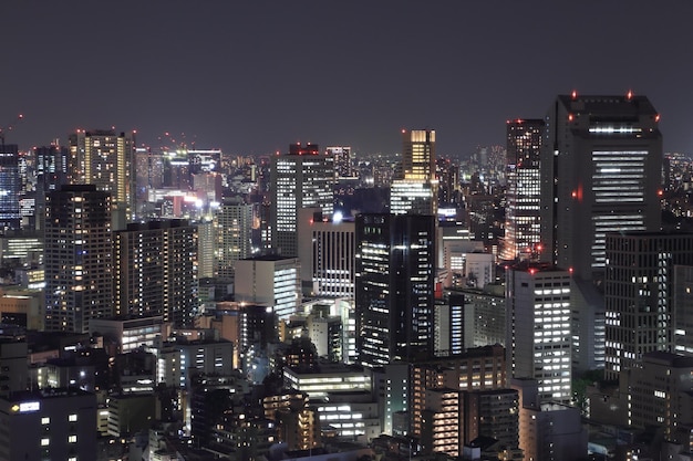 Illuminated cityscape against sky at night