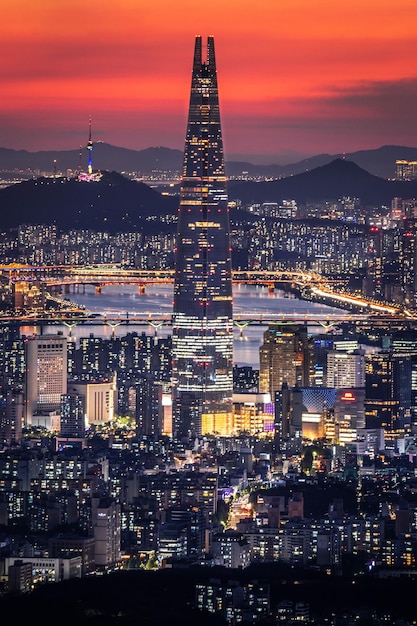 Illuminated cityscape against sky at night