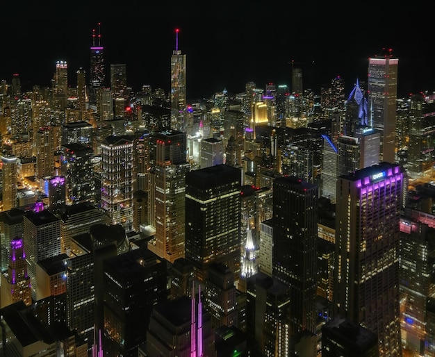 Illuminated cityscape against sky at night