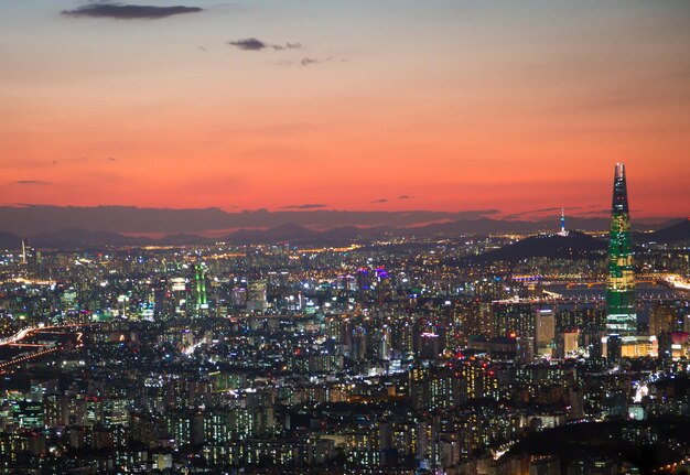 Illuminated cityscape against sky at night