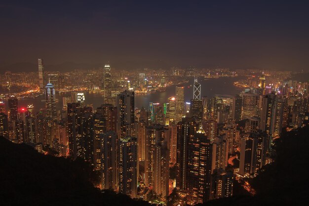 Illuminated cityscape against sky at night