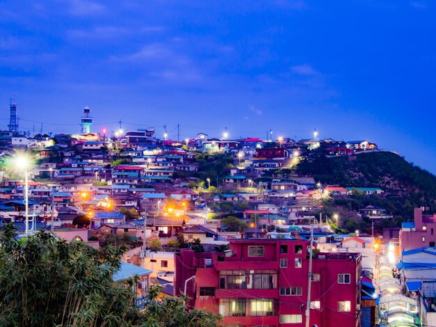 Illuminated cityscape against sky at night