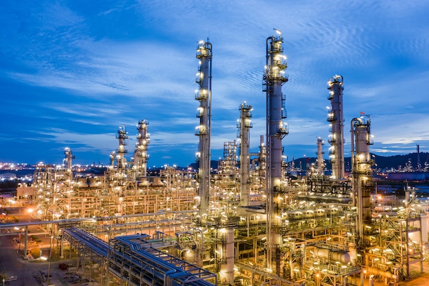 Illuminated factory against sky at night