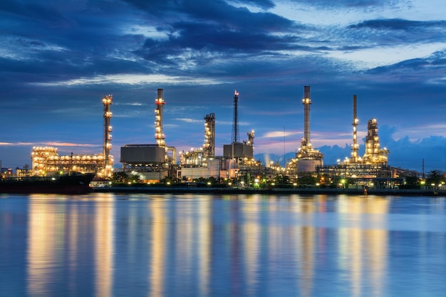 Illuminated factory against sky at night