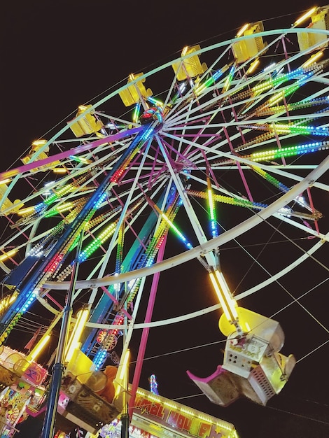 Illuminated ferris wheel at night