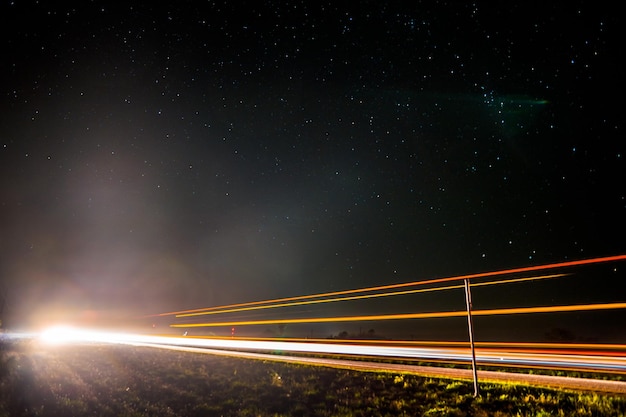 Photo illuminated field against sky at night