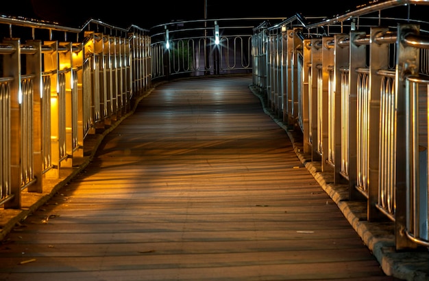 Illuminated footbridge at night