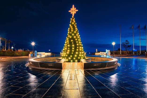 Illuminated fountain in city at night