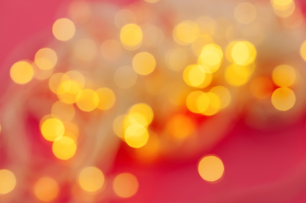 Illuminated garland lights on bright pink 