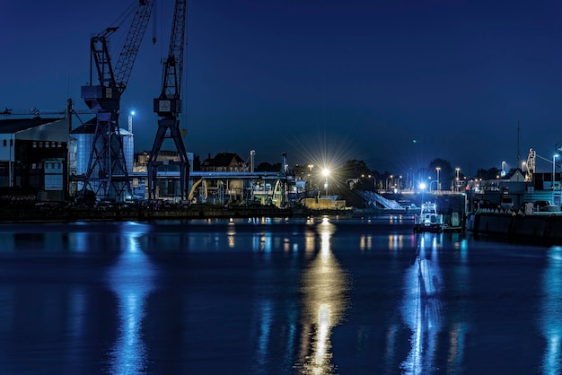 illuminated harbor with water reflection by night