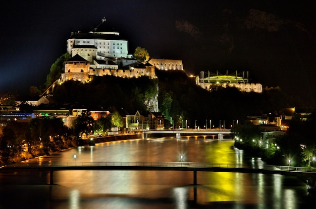 illuminated kufstein fortress against sky at night