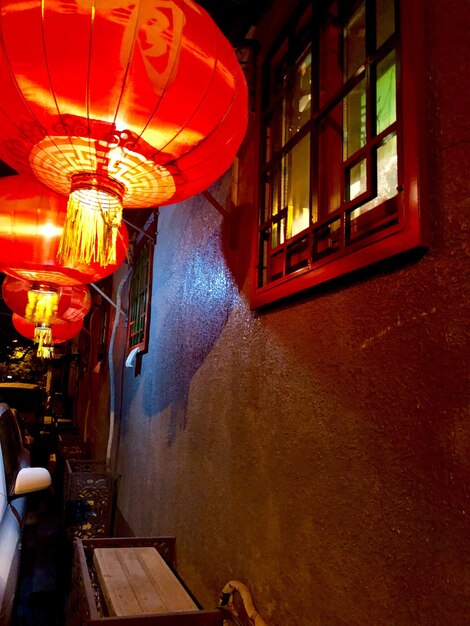 Illuminated lantern hanging in building