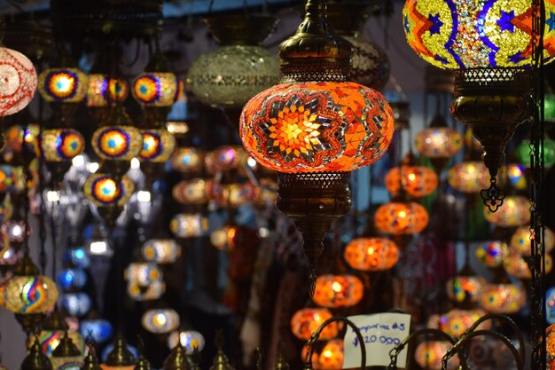 illuminated lanterns hanging in store for sale at market
