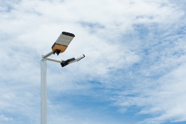 Illuminated LED streetlight on cloudy day