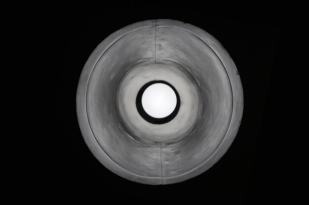 Photo illuminated light bulb against black background