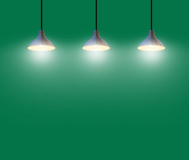 illuminated light bulbs hanging against green background