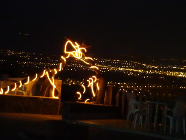 Illuminated lights against sky at night