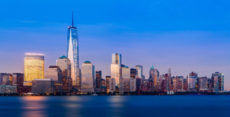 Photo illuminated lower manhattan buildings by hudson river