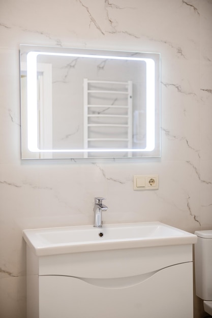 Illuminated mirror in the new bathroom in the house