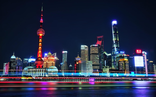 Photo illuminated modern buildings against sky in city at night