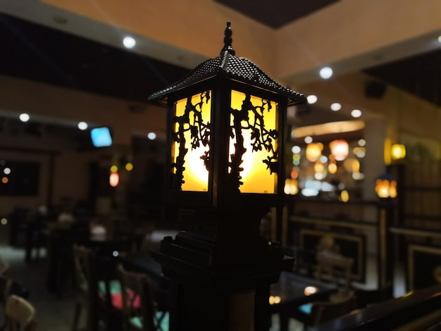 Photo illuminated pendant lights hanging in restaurant