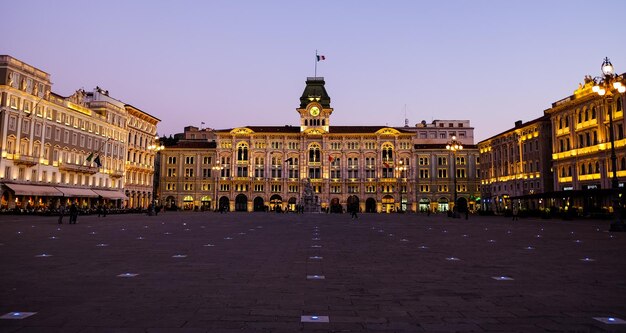 Photo illuminated piazza unita d italia against clear sky at dusk