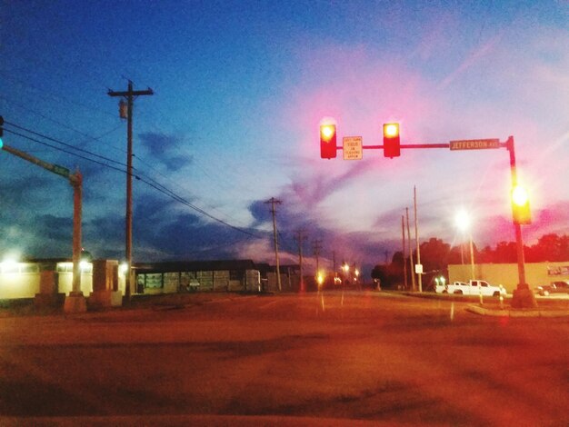 Illuminated road against sky