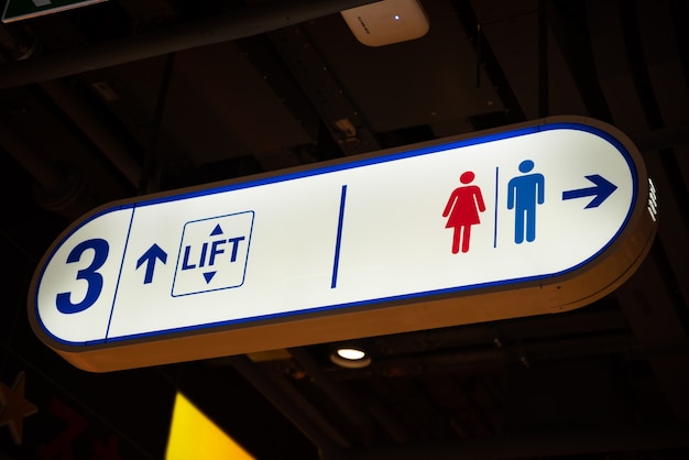 Illuminated signboard Level toilet parking lift in shopping mall.