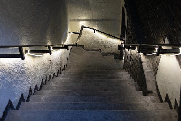 Illuminated staircase leading down to the basement