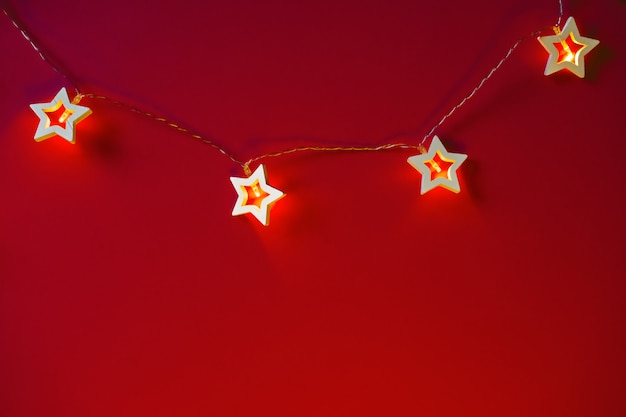 Illuminated star shaped garland on color  close up