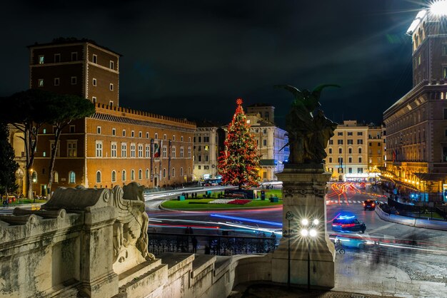 Foto statua illuminata per strada contro gli edifici di notte