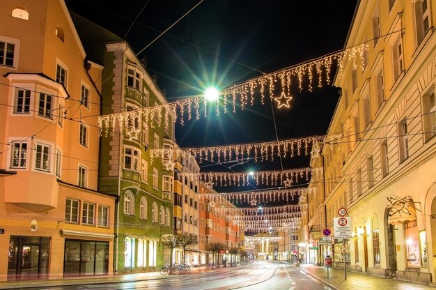 Illuminated street amidst buildings in city at night