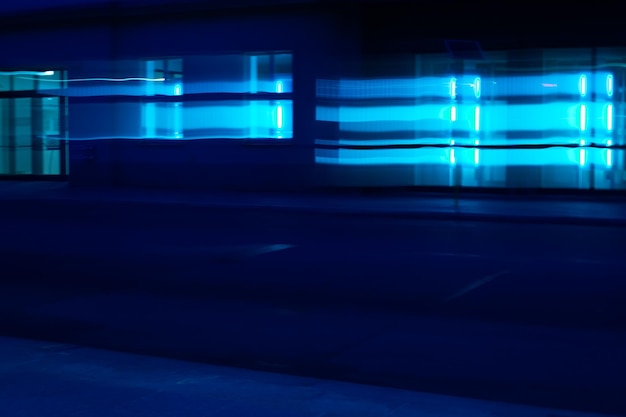 Illuminated street light against building at night