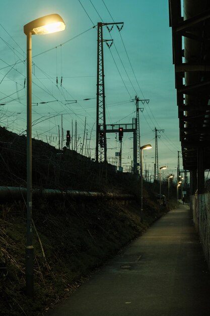 Illuminated street light against sky