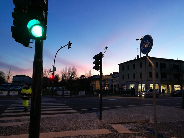 Illuminated street light in city at night