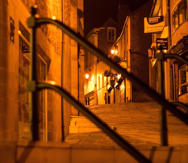 Illuminated street light in city at night