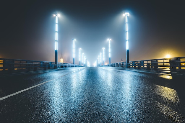 Illuminated street lights on bridge at night