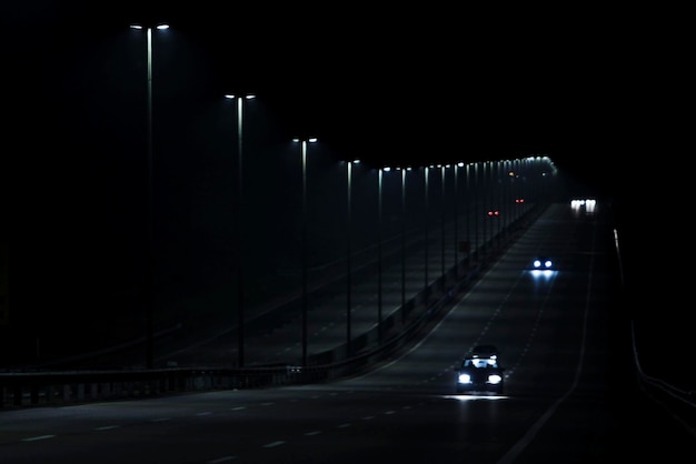 illuminated street lights on road at night