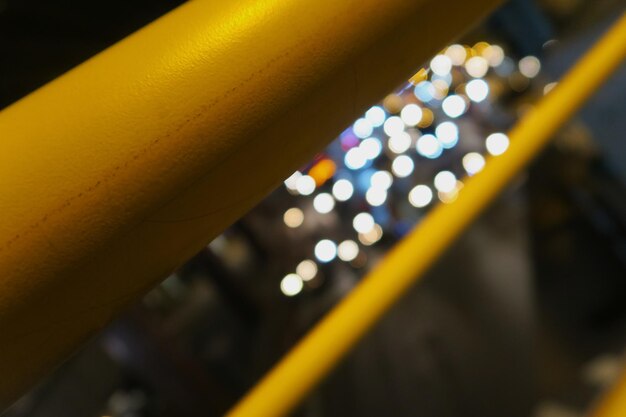 Illuminated street seen through railing at night