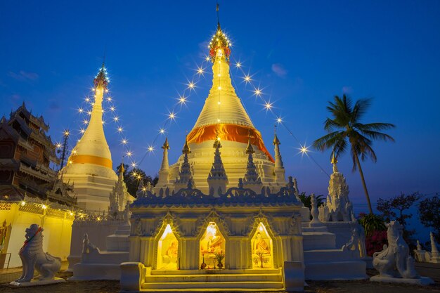 Illuminated temple building against sky