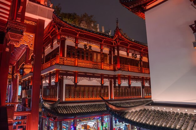 illuminated traditional chinese building with intricate carvings in shanghai