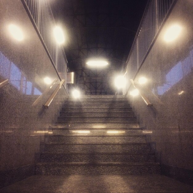 Illuminated tunnel at night