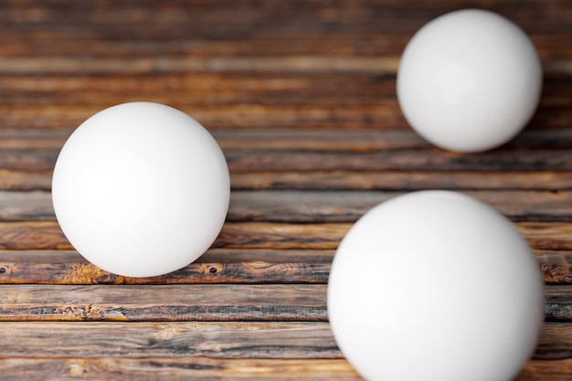 Foto illustratie van drie witte ballen op een houten tafel