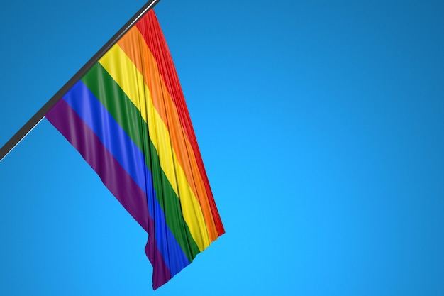 Photo illustration of the flag of lgbt on a metal flagpole fluttering against the blue sky