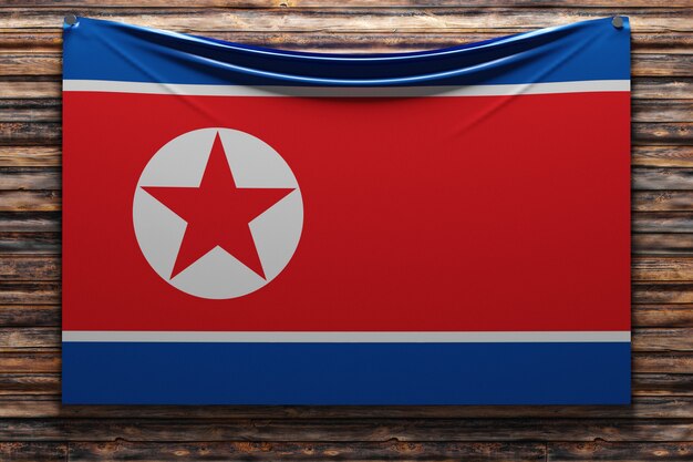 illustration of the national   fabric flag of North Korea  nailed on a wooden wall