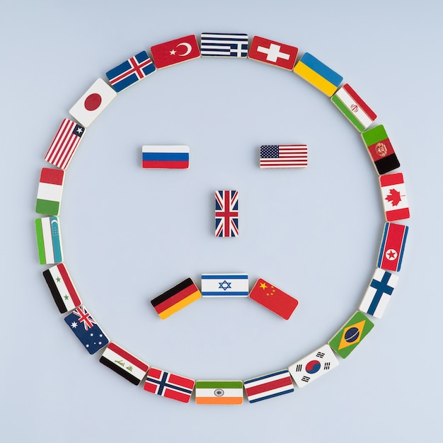 Photo illustration of a smiley face from national flags on dominoes concept of peace and the commonwealth