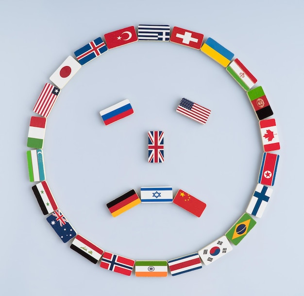 Photo illustration of a smiley face from national flags on dominoes