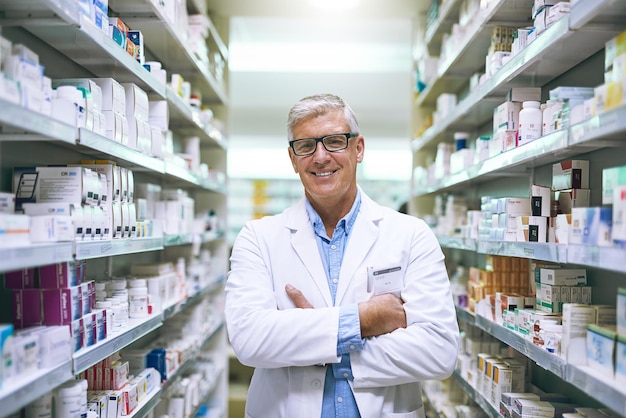 Im confident that youll get better with me to help you Portrait of a cheerful mature male pharmacist standing with his arms folded while looking at the camera in a pharmacy