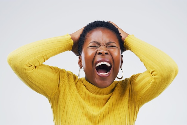 Im done with this Studio shot of an attractive young woman looking stressed out against a grey background